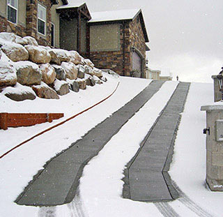 Concrete driveway with heated tire tracks.